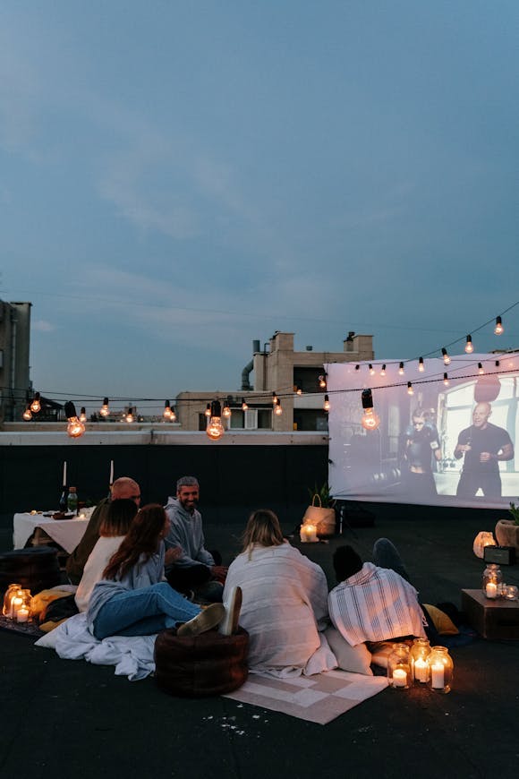 Serata cinema sul balcone con mini proiettore in ambiente domestico